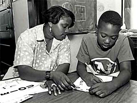 Child and adult at a table
